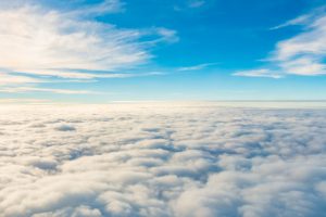 Sunrise above clouds from airplane window .