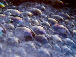 Discuss the nature of soap bubbles when exposed to sunlight. 2